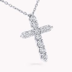 A precious interpretation of a classic motif, our mini cross pendant in white gold is available in a variety of different carat weights, seen here with 0.05 carat diamonds. Deftly suspended from a white gold chain, each diamond is embraced by a minimal metal setting, optimising their brilliance and presence. The Classic Graff collection celebrates the purity and fire of the finest Graff diamonds showcased in truly timeless jewels and eternally elegant silhouettes. An elegant Classic Graff cross Elegant Diamond White Crucifix Diamond Necklace, White Gold Formal Diamond Cross Pendant Necklace, Formal White Gold Cross Pendant Diamond Necklace, White Gold Formal Cross Pendant Necklace, Luxury White Gold Cross Necklace For Formal Occasions, Diamond White Cross Pendant Necklace With Prong Setting, White Gold Diamond Cross Pendant, Diamond Cross Necklace With Prong Setting, Classic Diamond Necklace With Brilliant Cut Cross Pendant