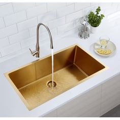 a kitchen sink with a faucet running from it