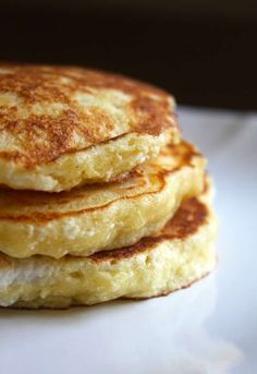 a stack of pancakes sitting on top of a white plate