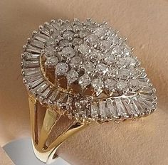 "This ring is gorgeous! It is from an Estate in New York City. The owner was an actress in the New York Theatre, and loved large diamond rings. This definitely fits the bill! It is a \"Ballerina\" design ring. The description of a Ballerina ring is \"fanciful and a distinctive style of gems\" in this case Diamonds! The cluster of Diamonds in the center simulates the flowing movement of a Ballerina dancing, and creates a swirling effect of Diamonds on the finger. Baguettes are usually used in thi New York Theatre, Large Diamond Rings, Ballerina Design, Ballerina Ring, Estate Ring, Ballerina Dancing, Estate Rings, 3 Carat, Anniversary Ring