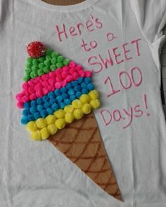 an ice cream cone is decorated with candy beads and has the words here's to sweet 100 days on it