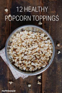 a bowl filled with popcorn sitting on top of a wooden table