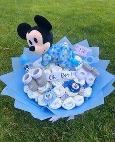 a mickey mouse baby shower bouquet on the grass