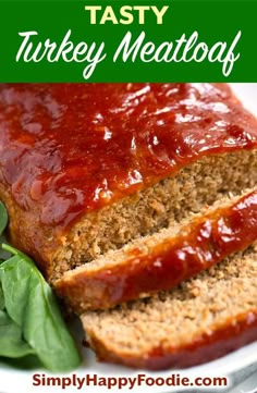 sliced meatloaf on a plate with spinach leaves