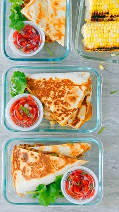 four plastic containers filled with different types of food and garnished in sauces