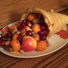 a plate filled with fruit and nuts on top of a wooden table