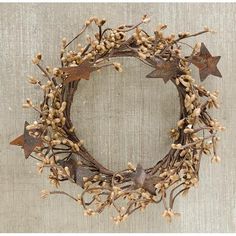 a wreath made out of branches with star decorations