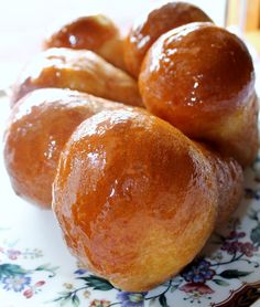 four donuts sitting on top of a floral plate