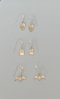 Tiny sterling silver Halloween charm earrings. Choose from the bat, ghost or skull. Sterling ear wires Whimsical Halloween Dangle Jewelry, Spooky Nickel-free Silver Earrings, Spooky Silver Pierced Earrings, Spooky Silver Nickel-free Earrings, Spooky Hypoallergenic Jewelry For Halloween, Spooky Silver Dangle Earrings, Handmade Sterling Silver Halloween Earrings, Spooky Nickel Free Jewelry For Halloween, Silver Spooky Halloween Earrings