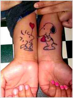 two people with matching tattoos on their arms