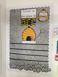 a bulletin board that has been made to look like a beehive and the words school is the place to go