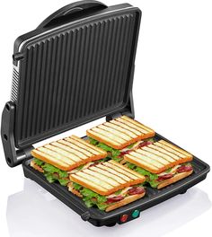 four sandwiches are being cooked in an electric griddle panini maker on a white surface