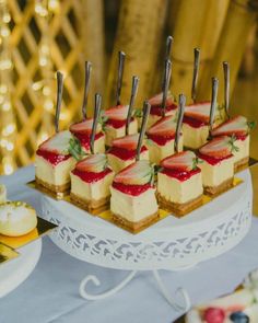 small desserts are arranged on a white platter