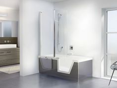 a white bathroom with a chair and shower