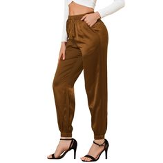 The pants take on a relaxed silhouette for the new season, with sports tailoring with tassel decor giving it a new fashionable elevated twist. Soft satin shapes the stylish pants with an elasticized, drawstring waist and straight legs. An ankle-length and a high-waisted further the cool style of the satin pants that are right for work and any casual occasion. Pair with the matching top for a complete look! Dressy Dark Brown Jogger Pants, Pocket Coffee, Planet Fashion, Loft Fashion, Athleisure Pants, Satin Joggers, Trendy Pants, Crop Dress, Joggers Pants