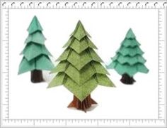 three paper christmas trees are shown on a white background with a ruler in the foreground