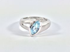 "Hi everyone, just wanted to let you know we are open and shipping daily. Beautifully crafted \"one of a kind\" contemporary Sterling Silver ring with genuine London Blue Topaz. The silver ring is finished with Rhodium so it will not tarnish. The gemstone used in this ring has been hand picked on a recent trip to Bangkok and is of a quality usually reserved for fine jewelry so you will almost never find such nice stones set in sterling silver! Weight 7.3 Grams This fine jewelry quality ring is p Modern Blue Topaz Ring With Accent Stones, Modern Sterling Silver Topaz Ring For Formal Occasions, Modern Silver Topaz Ring, Modern Topaz Promise Ring, Modern Silver Blue Topaz Ring, Modern Silver Hallmarked Topaz Ring, Modern Hallmarked Silver Topaz Ring, Modern Solitaire Topaz Ring Gift, Modern Silver Sapphire Ring With Accent Stones