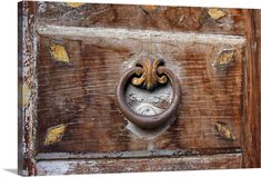 an old wooden door with a metal handle