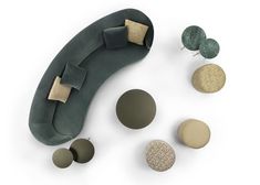 an assortment of different types of buttons and magnets on a white surface, including a green couch