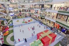 an overhead view of a mall with people skating on the ice and christmas decorations in the background