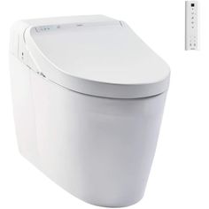 a white toilet sitting next to a wall mounted remote control