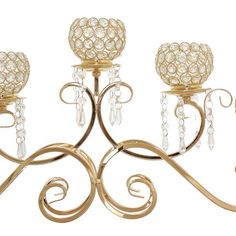 three candle holders with crystal balls on them