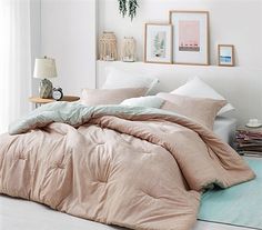 an unmade bed in a white bedroom with pink comforter and pillows on the floor