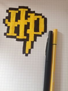 a pen sitting on top of a notebook next to a piece of paper with an image of a pacman