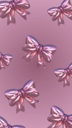 a pink bow is shown in the middle of an image with many smaller bows on it