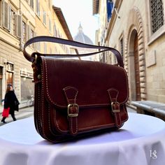 This bag has been made of the best genuine leather by local master crafters of Florence in Italy, designed for women who only accept premium Italian quality and luxury leather bags and modern Italian fashion. . Sizes: Width:   27 cm/10.75 inch Height:  18 cm/7 inch Depth:    11 cm/4.25 inch The story of this bag: Alessandro was on a mission to find the perfect gift for his girlfriend's upcoming anniversary. He wanted to surprise her with something special, something that would show her how much he cared. He knew she loved fashion and always admired the beautiful leather bags made in Florence. He thought it would be the perfect gift, but with so many options to choose from, he was feeling overwhelmed. He scoured the shops, but couldn't seem to find the right one. One day, he stumbled upon a Classic Vegetable Tanned Leather Crossbody Shoulder Bag, Luxury Leather Flap Bag As Gift, Luxury Leather Flap Bag Gift, Luxury Leather Flap Bag For Gifts, Luxury Vegetable Tanned Leather Shoulder Satchel, Classic Italian-made Satchel Bag, Italian Leather Bag As Gift, Classic Crossbody Bag In Vegetable Tanned Leather, Italian Leather Bag As A Gift