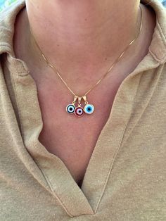 Dainty and waterproof, our Evil Eye necklace is the perfect everyday staple piece! Information: 🧿 18K Gold Filled (stamped) 🧿 Hypoallergenic 🧿 Tarnish Resistant 🧿 Waterproof Our Evil Eye necklace is carefully crafted with a high level of craftsmanship and attention to detail. For instance, you can see this in the high polishing of the necklace to the waterproof properties. The charm is reversible, you will be able to see the Evil Eye on both sides of the charm. Our necklace comes in 3 colors:  🧿 Red 🧿 Blue 🧿 White If you would like a longer length than what is listed, chain extensions are available upon request free of charge.  The Evil Eye 🧿 is known as a talisman of protection against evil energies, keeping the wearer safe from harm. This necklace makes a great gift. Red Evil Eye Jewelry, Red Round Pendant Charm Necklace, White Evil Eye, Red Evil Eye, Gold Charm Necklace, Protection Necklace, The Evil Eye, Evil Eye Charm, Evil Eye Necklace