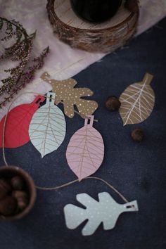 paper leaves and acorns on a table