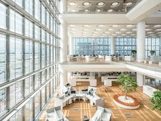 an office building with lots of windows and furniture