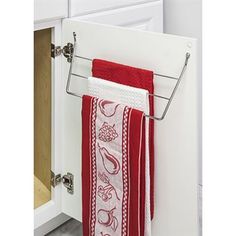 two towels hanging on a towel rack in a bathroom with white cabinet doors and drawers