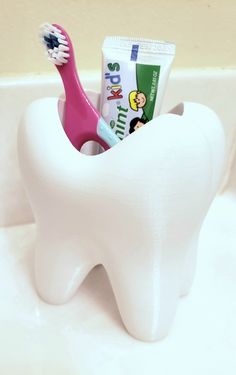 A fun addition to any kids or fun-loving adult's bathroom! Holds both children's and adult's toothbrushes with toothpaste. Drain hole allows any water to drain out keeping base dry and mildew free. This holder is 3D printed using high quality, food safe, durable PETG plastic that is as much as 10x stronger than most other 3D prints that use PLA. Buyer will receive toothbrush holder alone. Toothbrush and toothpaste only for photo demonstration purposes. Design credit: ericman93 at thingiverse.com Fun Toothbrush Holder, Development Psychology, Aperture Science, Toothbrush And Toothpaste, Toothbrush And Toothpaste Holder, Toothbrush Holders, Jewellery Holder, Toothpaste Holder, Gadgets Technology