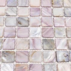 a close up view of a mosaic tile with white and pink tiles on the bottom