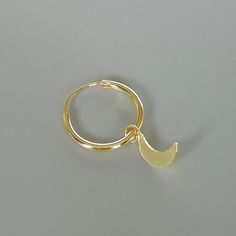 A PAIR of sterling silver hoops dipped in gold. Comes with a tiny crescent moon charm. The charm is multipurpose and can be used with a neck or bracelet chain too. Dimension: Hoop- 12x1 mm Charm- 4 x 9mm Drop length- 18 mm This piece is made of 925 hypoallergenic sterling silver. All my pieces are sent in a gift box. I can include a personal message from you if needed. You are welcome to contact me at... bhavnakwintra1956@gmail.com More hoops: https://www.etsy.com/your/shops/TheSilverGame/tools/ Gold Half Moon Hoop Earrings With Moon Charm, Gold Round Cartilage Earrings With Moon Charm, Moon Charm Hoop Earrings In Celestial Style, Adjustable Moon Charm Hoop Earrings, Adjustable Hoop Earrings With Moon Charm, Celestial Hoop Earrings With Moon Charm, Celestial Round Hoop Earrings With Moon Charm, Dainty Huggie Earrings With Moon Charm, Dainty Dangle Hoop Earrings With Moon Charm