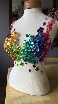 a white mannequin with multicolored sequins on it's back