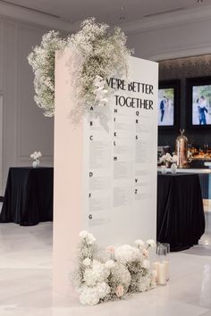 a table with flowers on it and a sign that says, ever better together at the end