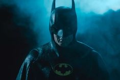 the dark knight in batman's costume is standing with his hands on his hips