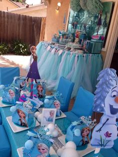 the table is set up for a frozen princess birthday party