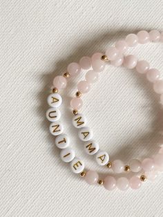 Fully Customizable Letter Bead Gemstone Stretch Bracelet in 6mm Rose Quartz. These bracelets make for a thoughtful and personalized gift!This listing is for ONE Customizable 6mm Rose Quartz Gemstone Letter Bead Stretch bracelet. All other photos are examples for how the bracelet can be paired with other pieces.All bracelets are handmade with strong elastic cord, gemstones 14K Gold Filled or Sterling Silver accent beads and plastic letter beads. The natural gem stones will have their own unique c Personalized Pink Stackable Bracelets, Pink Stackable Name Bracelet With Round Beads, Pink Stackable Round Beads Name Bracelet, Pink Beaded Bracelet Gift For Mom With Round Beads, Pink Beaded Bracelets Round Beads Gift For Mom, Pink Round Beaded Bracelet Gift For Mom, Pink Beaded Bracelet Gift For Mom, Personalized Pink Bracelets As Gift For Mom, Personalized Pink Bracelet As A Gift For Mom