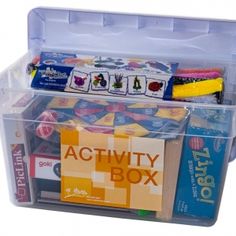 a plastic storage box filled with lots of different types of toys and books on top of each other