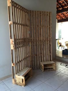 two wooden benches sitting in front of a wall made out of pallet wood planks