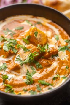 a bowl filled with food and garnished with cilantro on the side