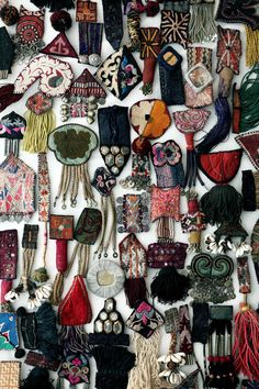 many different types of purses hanging on a wall