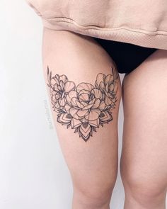 a woman's thigh with flowers on it