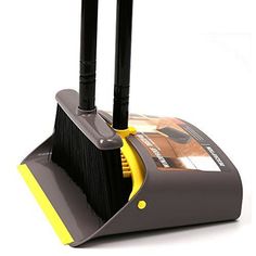 two black and yellow brooms sitting next to each other on top of a white surface