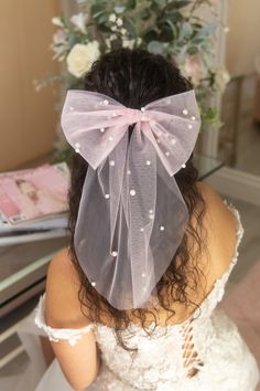 Add an adorable blush pearl tulle hair bow to your bridal look! Bows are an effortless hair accessory, perfect for your wedding day, bachelorette parties, bridal showers, honeymoon, and more. This would also make a great gift for the bride-to-be and bridesmaids! Trendy hair bows are an elegant veil alternative. This bow measures 8" wide with 12" long tails, and it features a durable alligator clip on the back for easy on and off.  *Care Instructions:  When storing your bow, avoid folding or scrunching too much to avoid wrinkling the tulle.  For light wrinkles, use the steam setting on an iron or a steamer to gently steam out the creases. DO NOT IRON! The iron may melt the tulle if it is too hot. If you have any additional questions, please feel free to reach out :) Tulle Hair Bow, Veil Alternative, Tulle Hair Bows, Elegant Veils, Effortless Hair, Sophisticated Hairstyles, Elegant Birthday Cakes, Tulle Bow, Beautiful Veil