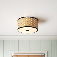 a bedroom with a bed, mirror and light fixture